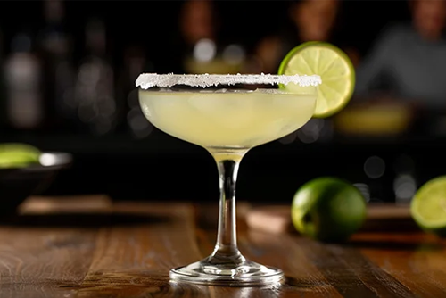 a margirita with a lime on the rim